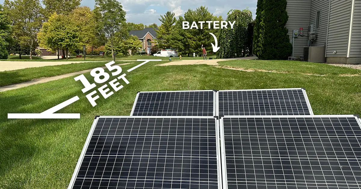 An image showing four 100-watt Thunderbolt solar panels in the foreground, 185 feet away from the battery in the distance, in order to test line loss.